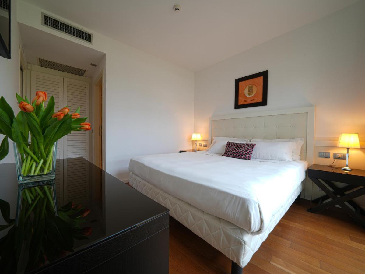 أبيتاليا تاور بلازا بيزا المظهر الخارجي الصورة A bedroom at the hotel